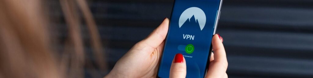 pexels-photo-2048774-2048774 Close-up of a woman's hands using a VPN app on a smartphone, emphasizing digital security.